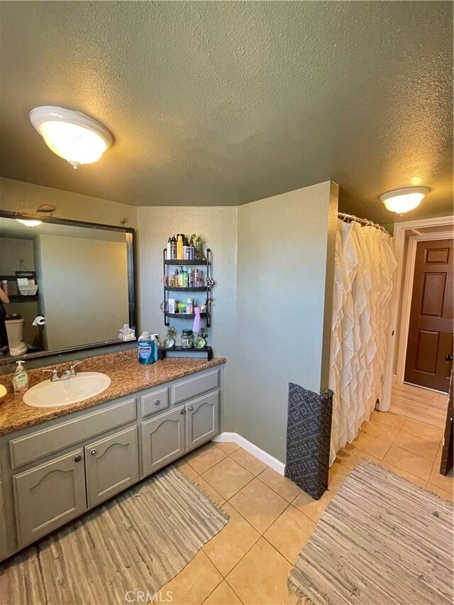10623 4th Ave, Hesperia, CA 92345 - bathroom with tile patterned floors, a textured ceiling, vanity, and a shower with curtain