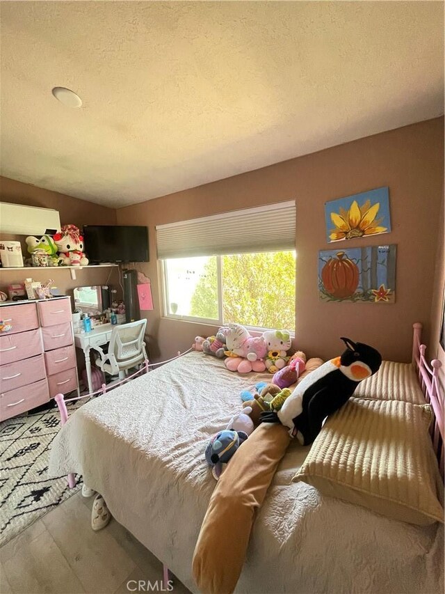 10623 4th Ave, Hesperia, CA 92345 - bedroom with wood finished floors and a textured ceiling