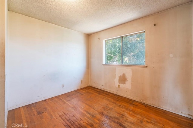17300 Buttonwood St, Fountain Valley, CA 92708 - spare room featuring hardwood / wood-style floors and a textured ceiling
