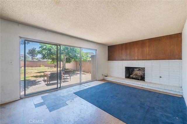 17300 Buttonwood St, Fountain Valley, CA 92708 - unfurnished living room with a fireplace, a textured ceiling, tile patterned floors, and wooden walls