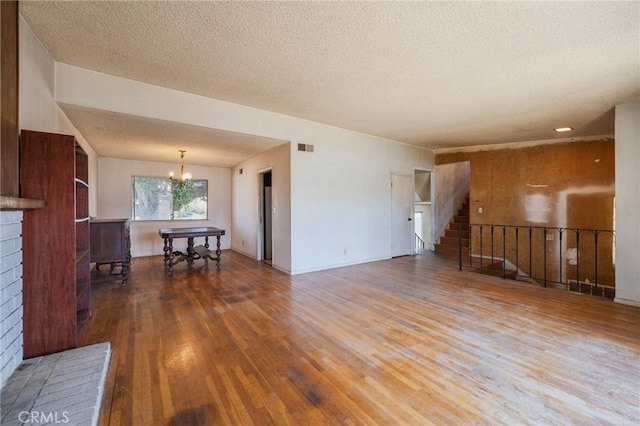 17300 Buttonwood St, Fountain Valley, CA 92708 - living area with hardwood / wood-style flooring, a chandelier, a textured ceiling, and stairs