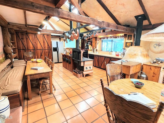 31351 Comptche Ukiah Rd, Comptche, CA 95427 - kitchen with stainless steel fridge with ice dispenser, a wood stove, light tile patterned flooring, and light countertops