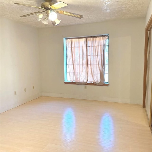 9078 Smith Rd, Phelan, CA 92371 - unfurnished room featuring a textured ceiling, light wood finished floors, and ceiling fan