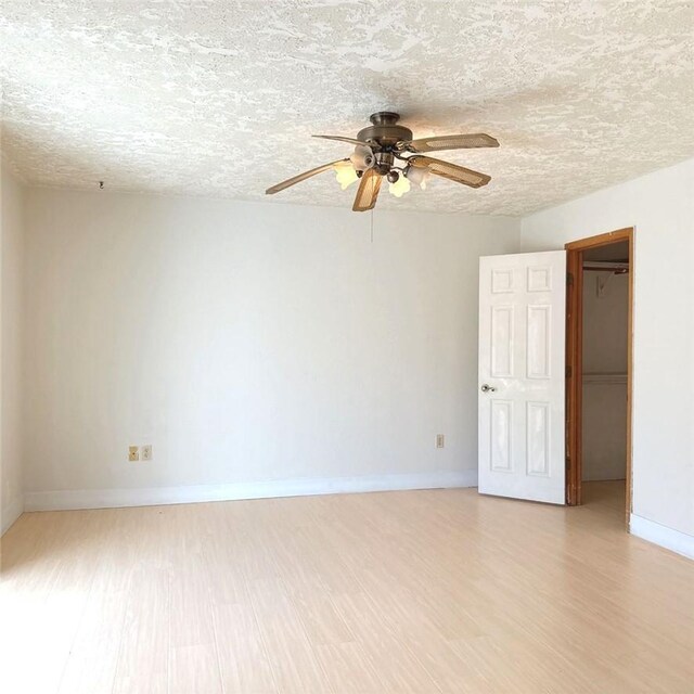 9078 Smith Rd, Phelan, CA 92371 - empty room featuring light wood-type flooring, ceiling fan, and a textured ceiling