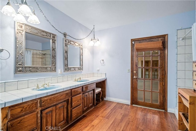 5908 Alleppo Ln, Palmdale, CA 93551 - bathroom with wood-type flooring, a chandelier, double vanity, and curtained shower