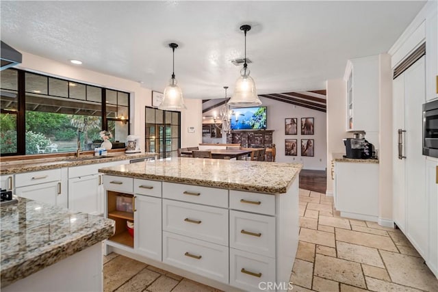 5908 Alleppo Ln, Palmdale, CA 93551 - kitchen with a kitchen island, white cabinets, stone tile floors, pendant lighting, and light stone countertops