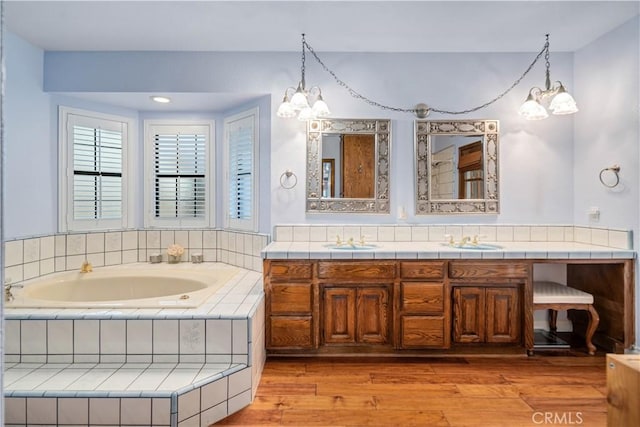 5908 Alleppo Ln, Palmdale, CA 93551 - full bathroom featuring a chandelier, a garden tub, vanity, and wood finished floors