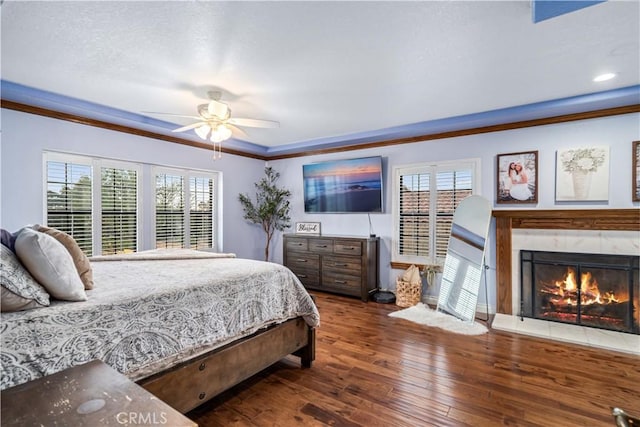 5908 Alleppo Ln, Palmdale, CA 93551 - bedroom with multiple windows, wood-type flooring, ornamental molding, a high end fireplace, and a ceiling fan