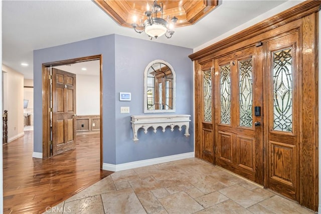 5908 Alleppo Ln, Palmdale, CA 93551 - entryway featuring a chandelier, recessed lighting, stone tile flooring, and a tray ceiling