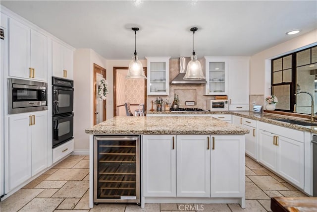 5908 Alleppo Ln, Palmdale, CA 93551 - kitchen featuring beverage cooler, wall chimney exhaust hood, white cabinetry, tasteful backsplash, and stainless steel microwave