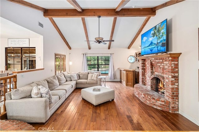 5908 Alleppo Ln, Palmdale, CA 93551 - living room with a ceiling fan, beamed ceiling, hardwood / wood-style floors, a brick fireplace, and high vaulted ceiling