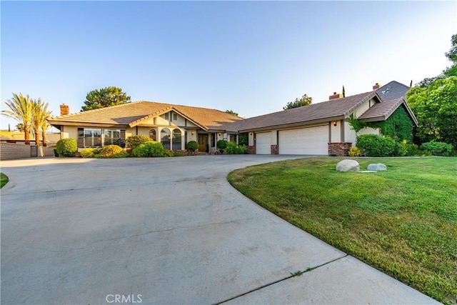 5908 Alleppo Ln, Palmdale, CA 93551 - view of front of home featuring driveway, a front yard, a chimney, and stucco siding