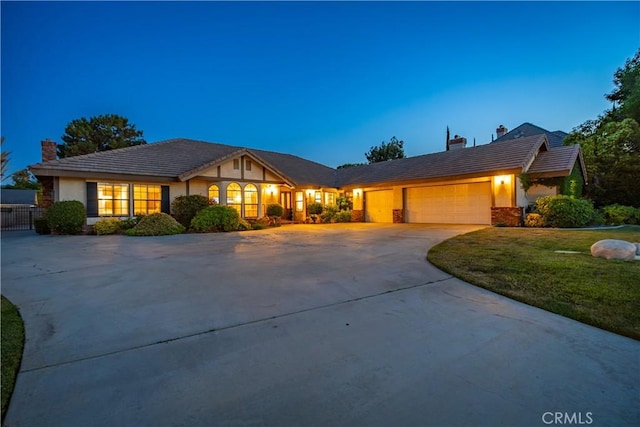 5908 Alleppo Ln, Palmdale, CA 93551 - view of front of home with a chimney, concrete driveway, a garage, stucco siding, and a front lawn
