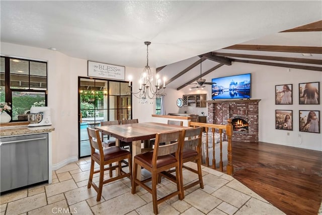 5908 Alleppo Ln, Palmdale, CA 93551 - dining room with a brick fireplace, a chandelier, stone tile flooring, and ceiling fan