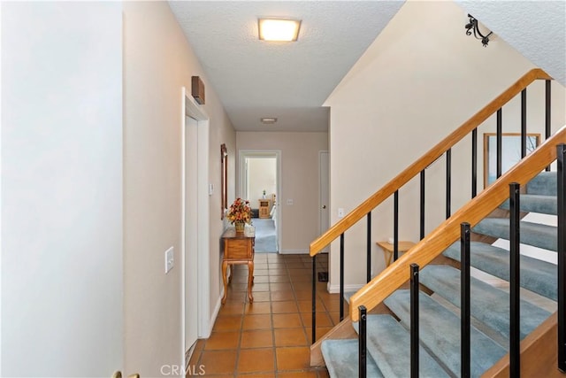 10 Mann St, Irvine, CA 92612 - staircase featuring tile patterned floors and a textured ceiling
