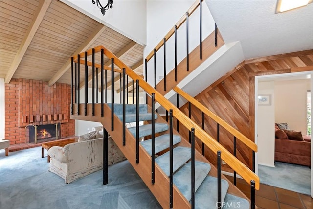 10 Mann St, Irvine, CA 92612 - stairs featuring carpet flooring, a brick fireplace, wooden walls, and wooden ceiling