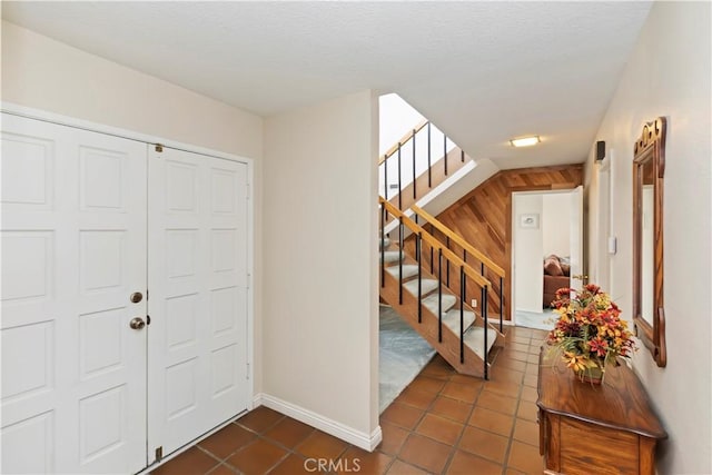 10 Mann St, Irvine, CA 92612 - entryway with dark tile patterned floors and stairs