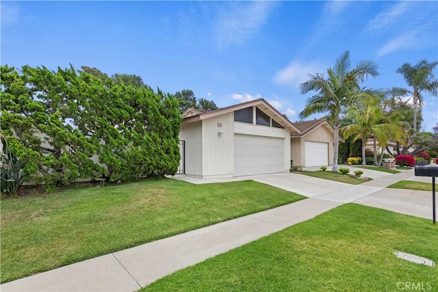 10 Mann St, Irvine, CA 92612 - view of front facade with a front lawn and a detached garage