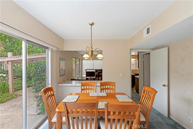 10 Mann St, Irvine, CA 92612 - dining area with a chandelier and carpet flooring