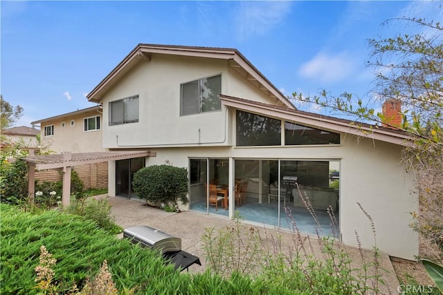 10 Mann St, Irvine, CA 92612 - back of house featuring stucco siding, a patio, a pergola, and a chimney