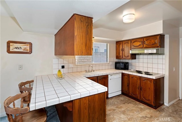 10 Mann St, Irvine, CA 92612 - kitchen with black microwave, white dishwasher, ventilation hood, decorative backsplash, and brown cabinets