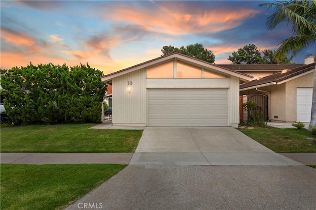 10 Mann St, Irvine, CA 92612 - view of front facade featuring a front yard, an attached garage, and concrete driveway