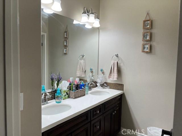 513 E Water St, Anaheim, CA 92805 - bathroom featuring decorative backsplash and double vanity