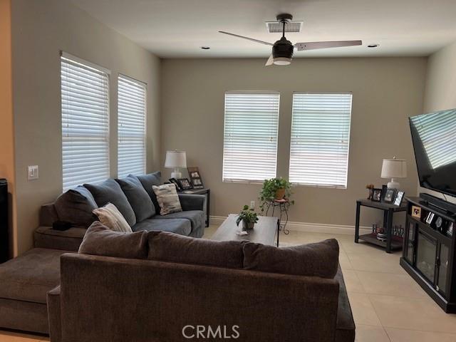 513 E Water St, Anaheim, CA 92805 - living room with ceiling fan, healthy amount of natural light, and light tile patterned floors