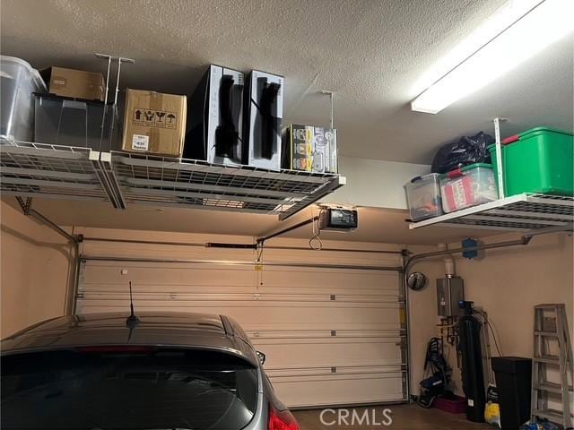 513 E Water St, Anaheim, CA 92805 - garage featuring water heater and a garage door opener