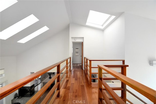 828 Wonder View Dr, Calabasas, CA 91302 - hallway with a skylight, an upstairs landing, lofted ceiling, and wood finished floors