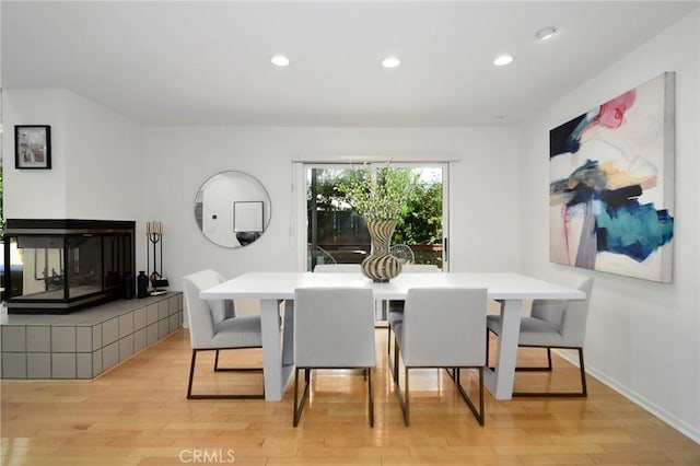 828 Wonder View Dr, Calabasas, CA 91302 - dining room with recessed lighting, light wood-type flooring, and a tiled fireplace