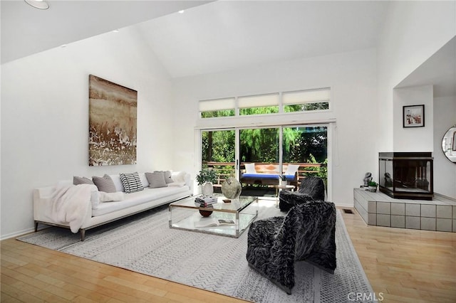 828 Wonder View Dr, Calabasas, CA 91302 - living room with wood finished floors, high vaulted ceiling, and a multi sided fireplace