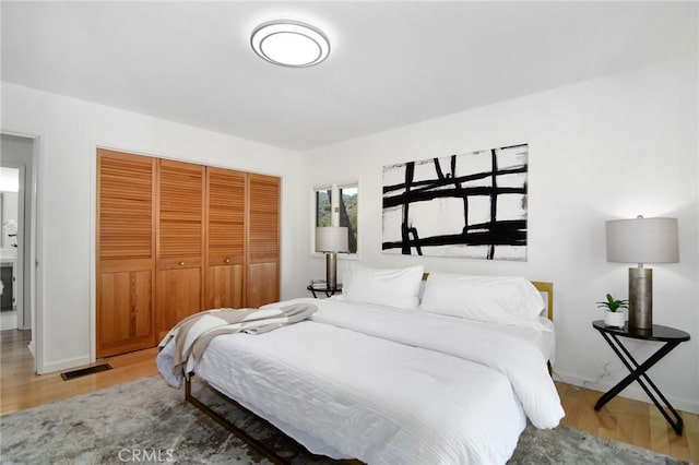 828 Wonder View Dr, Calabasas, CA 91302 - bedroom featuring wood finished floors and a closet