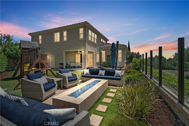 11 Juniper, Lake Forest, CA 92630 - rear view of house featuring an outdoor living space with a fire pit, a playground, a patio, and stucco siding