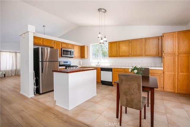 44303 Freer Way, Lancaster, CA 93536 - kitchen featuring appliances with stainless steel finishes, a center island, high vaulted ceiling, hanging light fixtures, and brown cabinetry