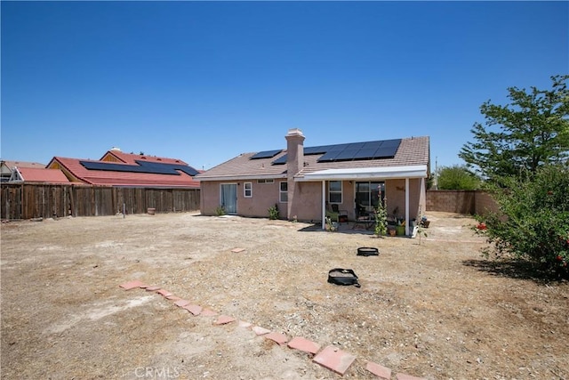 44303 Freer Way, Lancaster, CA 93536 - rear view of house featuring solar panels, a fenced backyard, a patio, and stucco siding