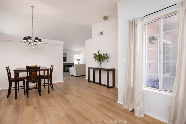 44303 Freer Way, Lancaster, CA 93536 - dining space featuring a chandelier, lofted ceiling, and light wood-style floors