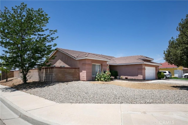 44303 Freer Way, Lancaster, CA 93536 - ranch-style home featuring an attached garage, stucco siding, a tiled roof, and concrete driveway
