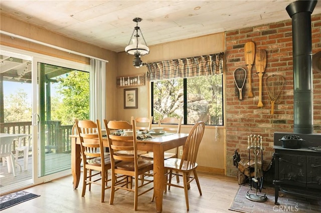 32953 Juniper Ln, Green Valley Lake, CA 92341 - dining space featuring a wood stove, wood finished floors, plenty of natural light, and wooden ceiling