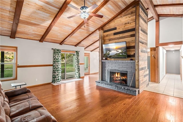 24050 Basin Harbor Ct, Tehachapi, CA 93561 - unfurnished living room with a wooden ceiling with exposed beams, light wood-style flooring, a fireplace, a ceiling fan, and high vaulted ceiling