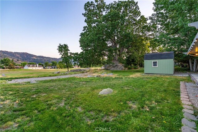 24050 Basin Harbor Ct, Tehachapi, CA 93561 - view of green lawn with a storage unit and a mountain view