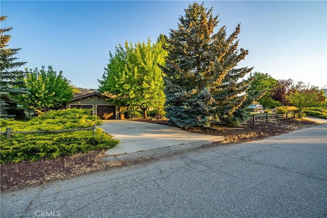 24050 Basin Harbor Ct, Tehachapi, CA 93561 - view of property hidden behind natural elements with a garage