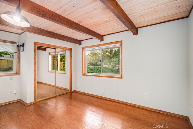 24050 Basin Harbor Ct, Tehachapi, CA 93561 - unfurnished bedroom with wood finished floors, multiple windows, a wooden ceiling with exposed beams, and a closet