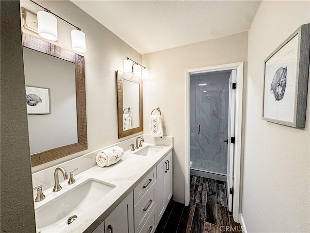 18602 Creek Ln, Huntington Beach, CA 92648 - full bath with double vanity, a shower stall, and wood finished floors