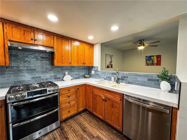 18602 Creek Ln, Huntington Beach, CA 92648 - kitchen with appliances with stainless steel finishes, under cabinet range hood, ceiling fan, dark wood-type flooring, and light countertops