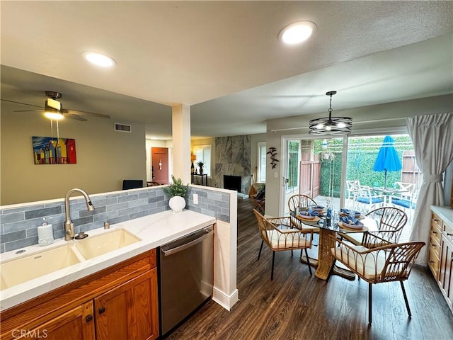 18602 Creek Ln, Huntington Beach, CA 92648 - kitchen featuring dishwasher, light countertops, a large fireplace, dark wood-type flooring, and brown cabinets