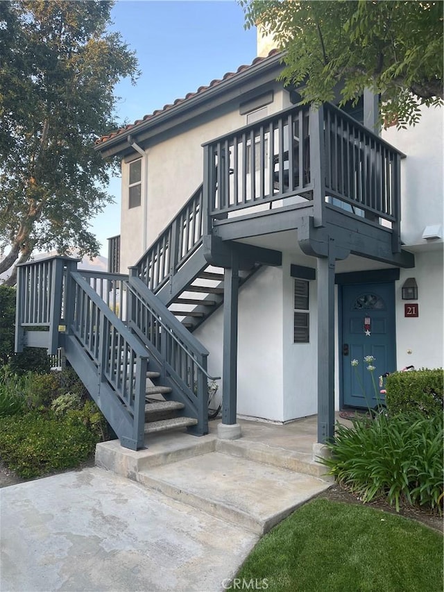 21 Lobelia, Rancho Santa Margarita, CA 92688 - rear view of house with stucco siding, a balcony, and stairs