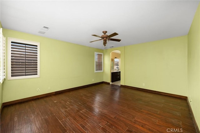 12975 Cambridge Ct, Chino, CA 91710 - empty room with arched walkways, a ceiling fan, and wood finished floors