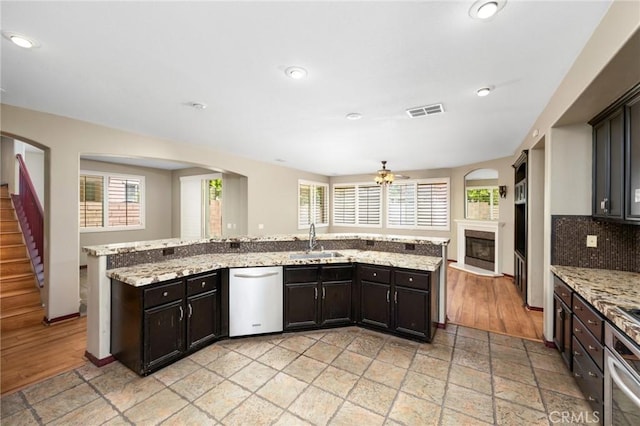 12975 Cambridge Ct, Chino, CA 91710 - kitchen with stainless steel appliances, plenty of natural light, a glass covered fireplace, open floor plan, and recessed lighting