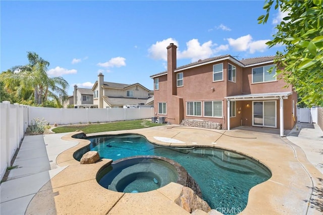 12975 Cambridge Ct, Chino, CA 91710 - view of swimming pool with a patio area, a fenced backyard, and a pool with connected hot tub